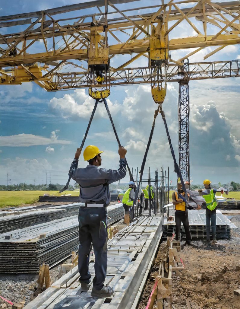 Cranes Lifting Steel Beams at Construction Site